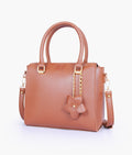 Buy Brown handbag with flower charm in Pakistan