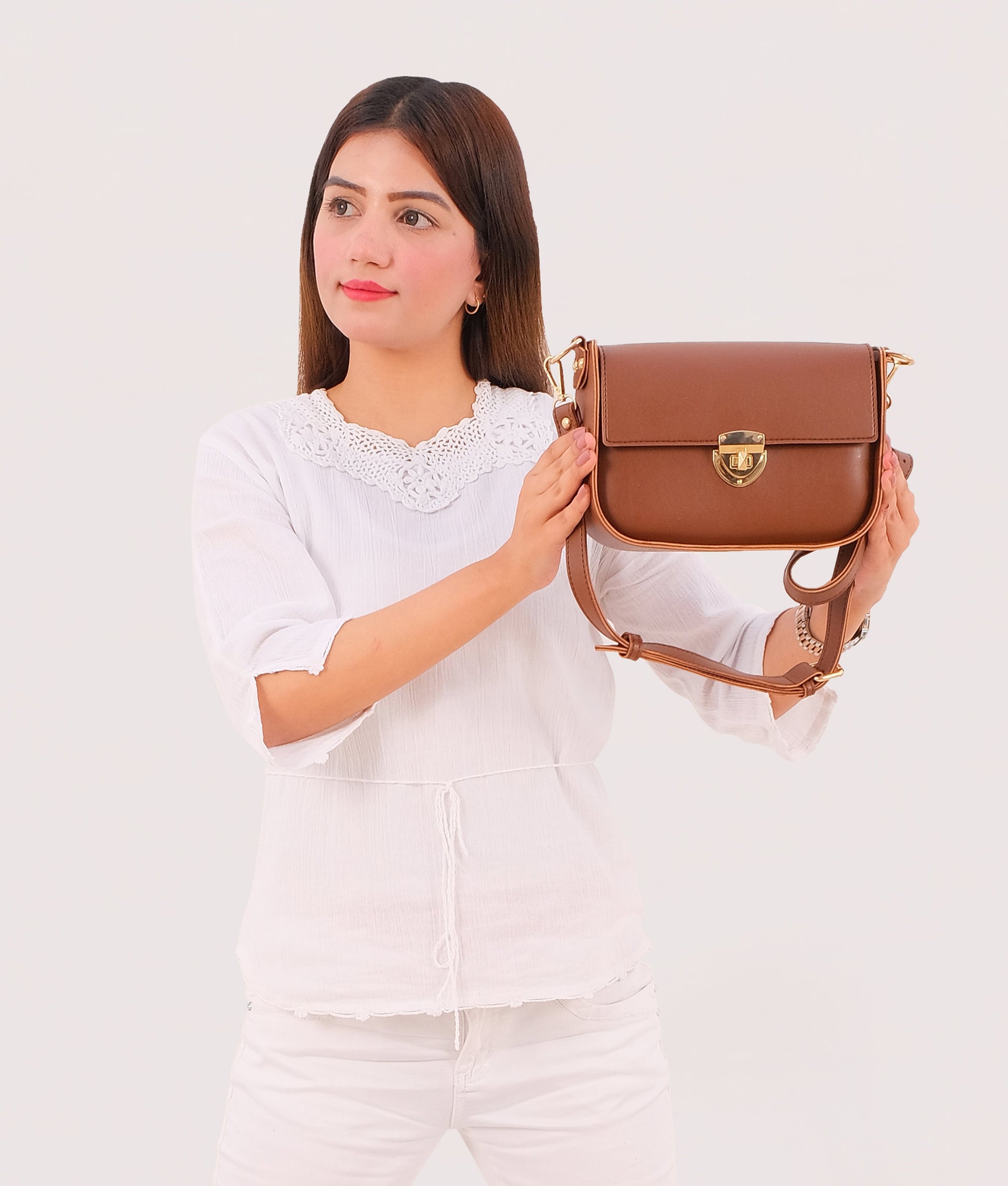 Buy Brown saddle bag with twist lock in Pakistan