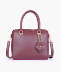 Buy Burgundy handbag with flower charm in Pakistan