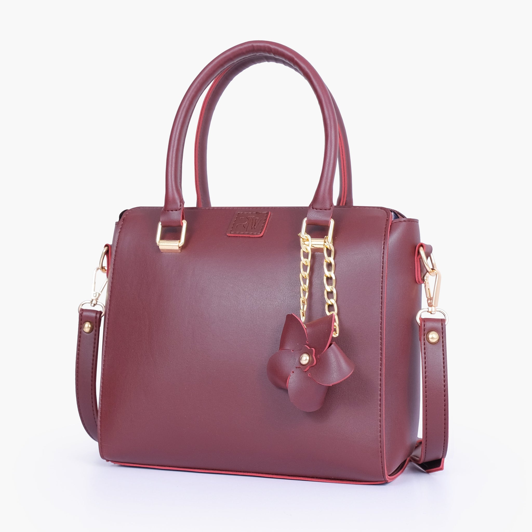 Buy Burgundy handbag with flower charm in Pakistan