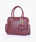 Buy Burgundy handbag with flower charm in Pakistan