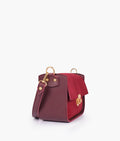 Buy Burgundy suede saddle bag with twist lock in Pakistan