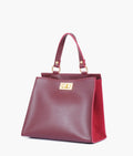 Buy Burgundy suede front lock top-handle mini bag in Pakistan