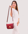 Buy Burgundy suede saddle bag with twist lock in Pakistan