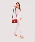 Buy Burgundy suede saddle bag with twist lock in Pakistan