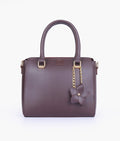 Buy Dark brown handbag with flower charm in Pakistan