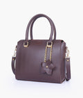 Buy Dark brown handbag with flower charm in Pakistan