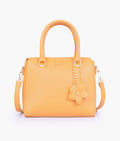 Buy Mustard handbag with flower charm in Pakistan