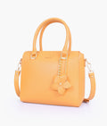 Buy Mustard handbag with flower charm in Pakistan