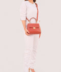 Buy Rust mini top-handle bag in Pakistan